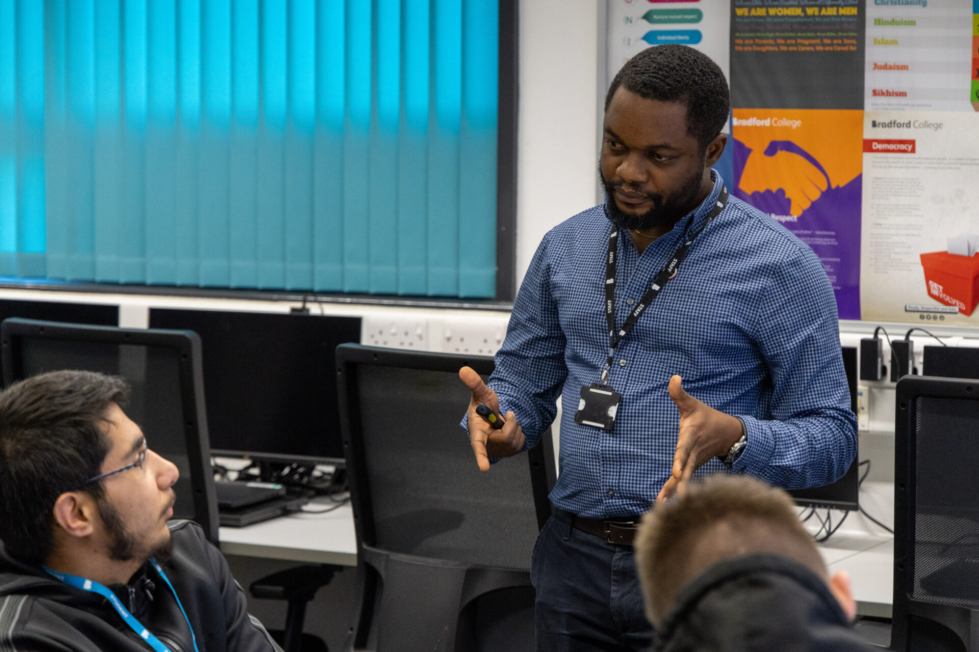 Male tutor speaking to male engineering student