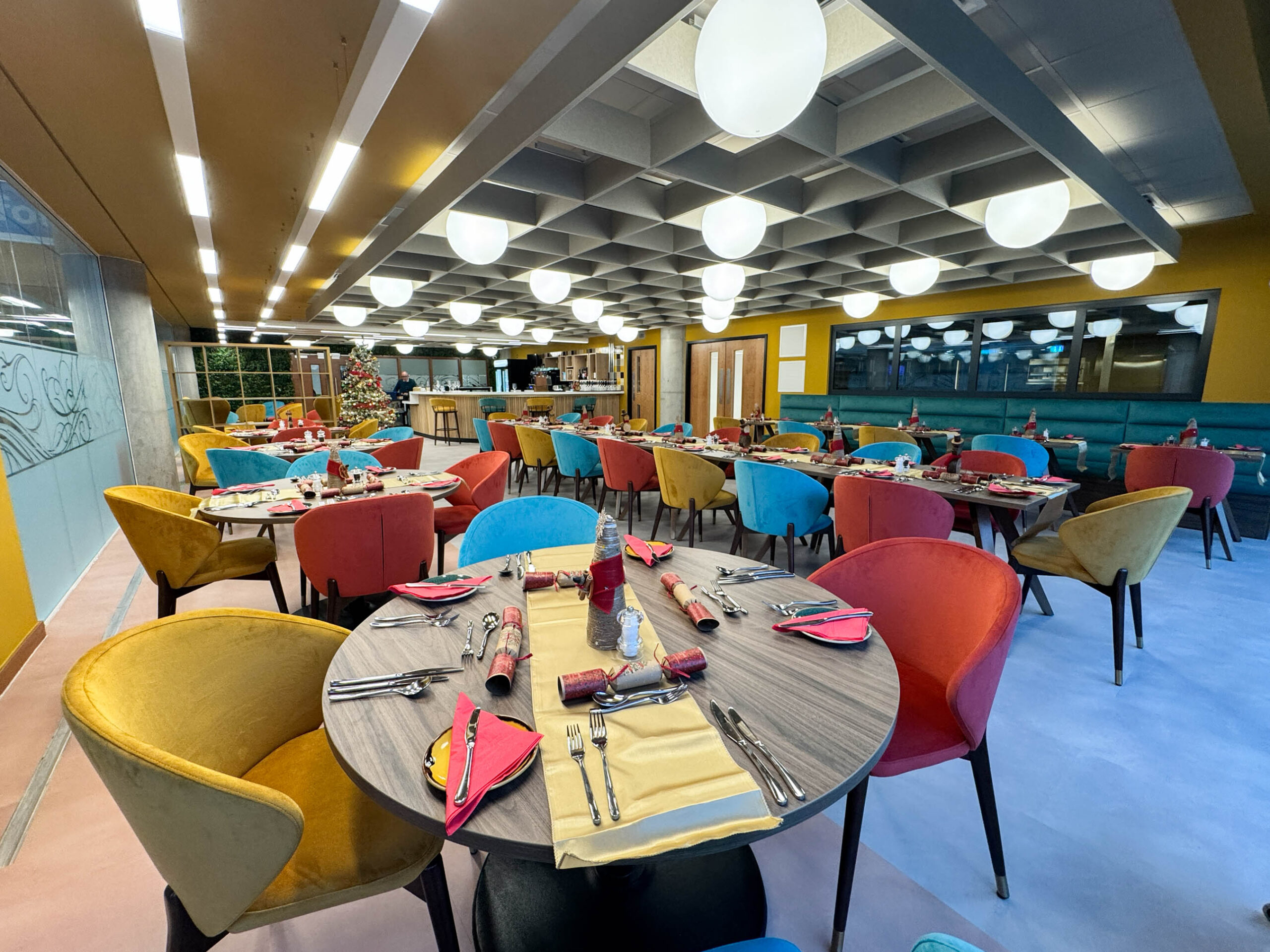 Internal shot of The Grove Restaurant, showing tables and chairs with the table set for dinner