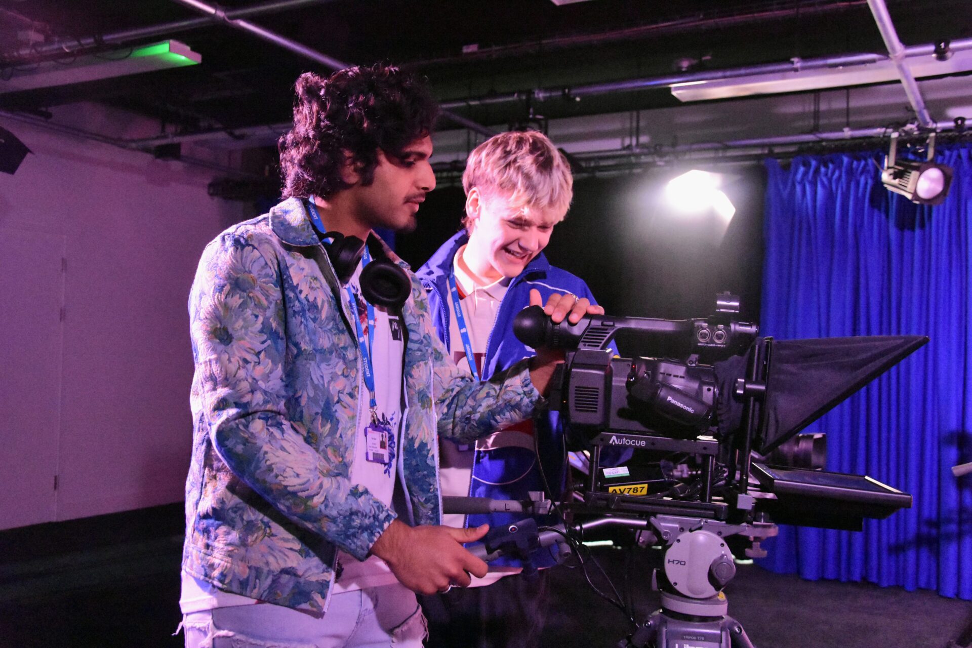 Two students stand and operate a video camera in the new Bradford College media facilities