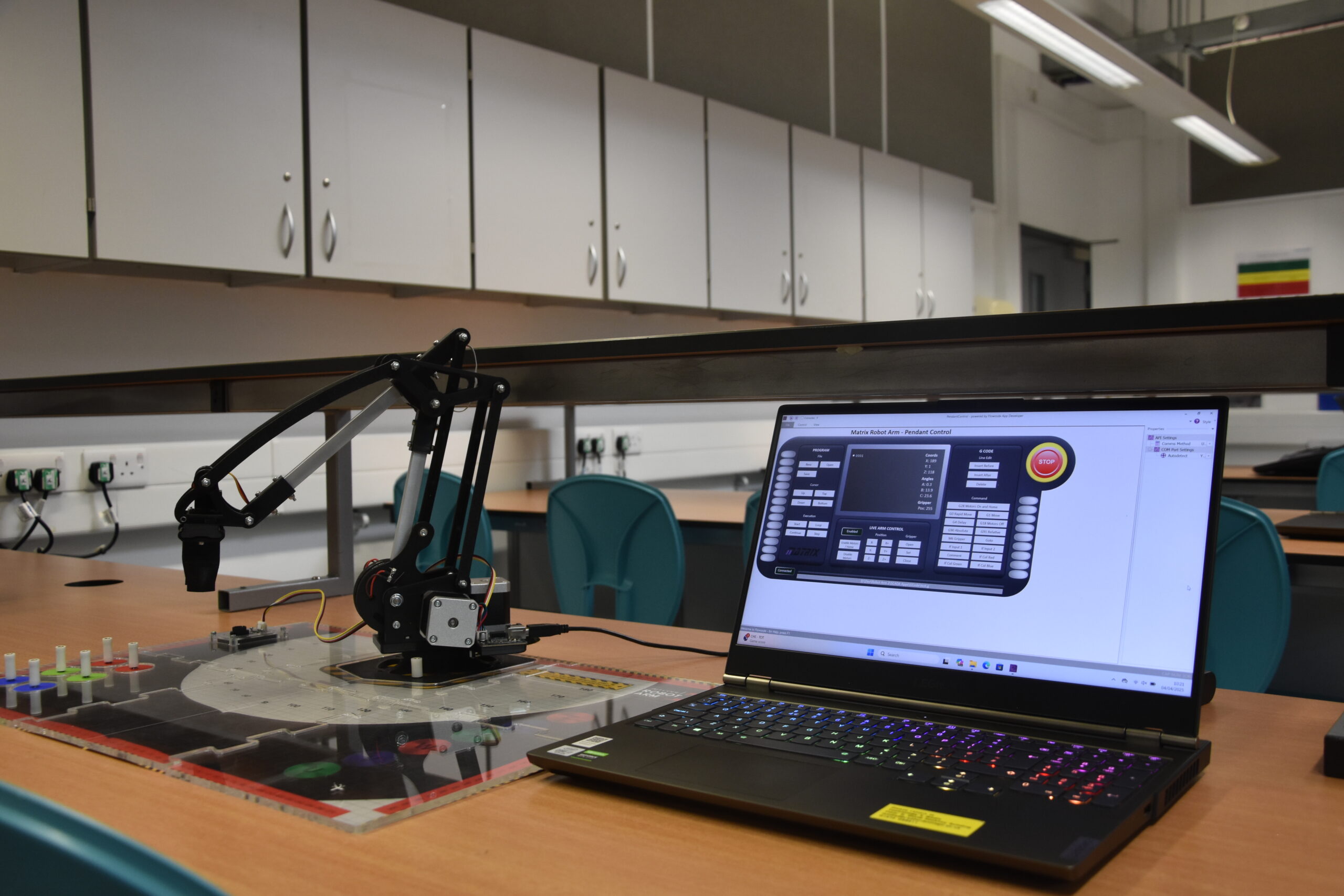 An image of a laptop with a robotic arm