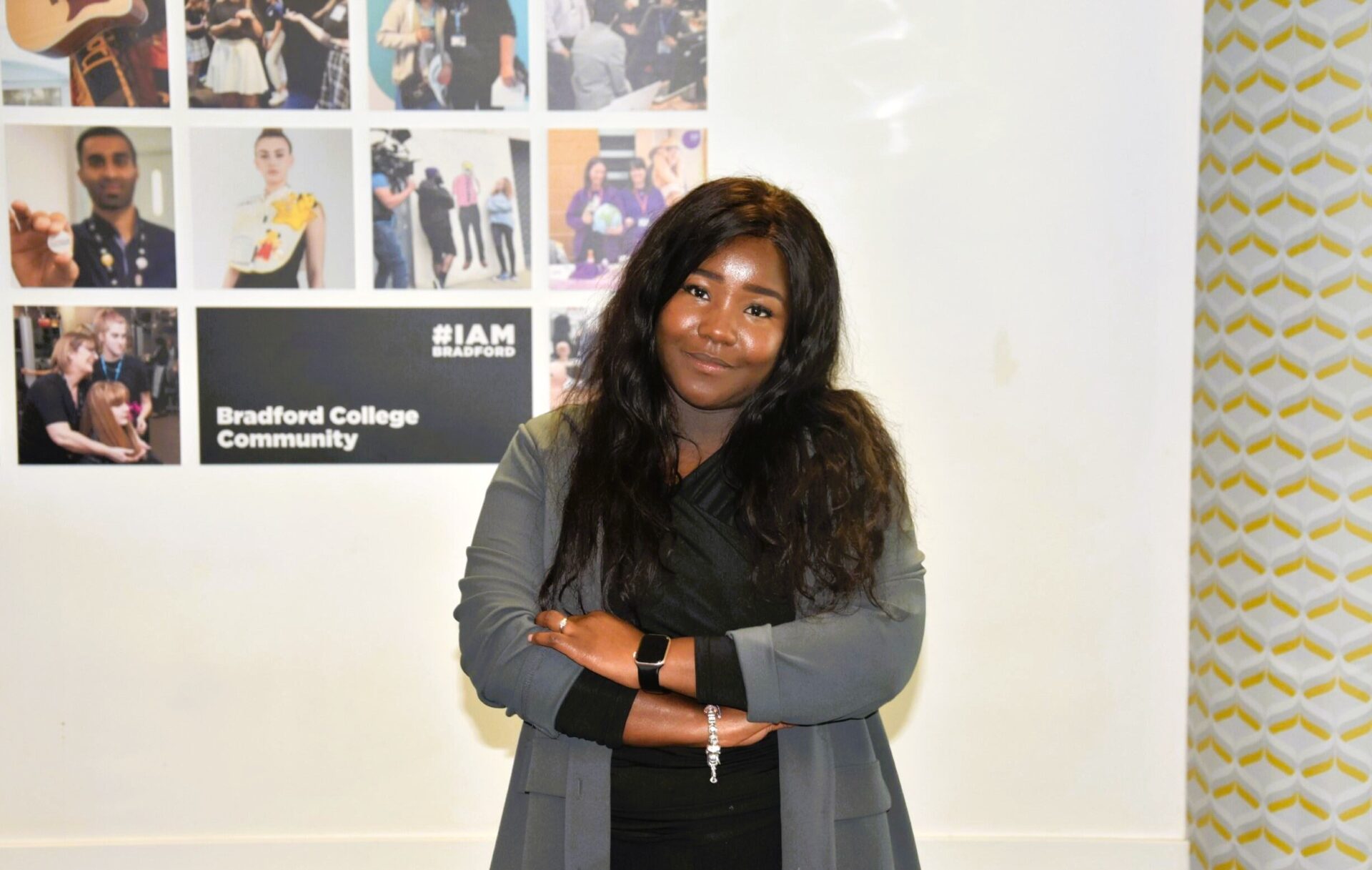 Hawa Kandeh smiling at the camera with her arms folded