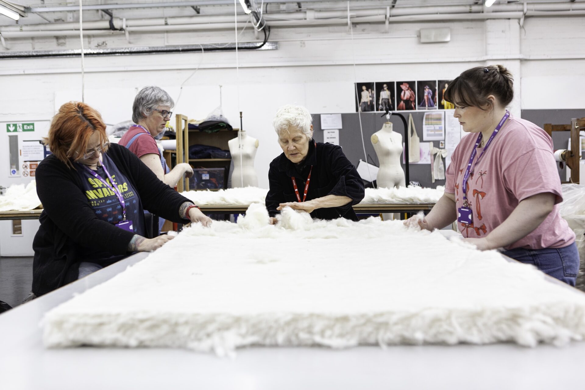 4 female students working on the fabric for the we will sign exhibition