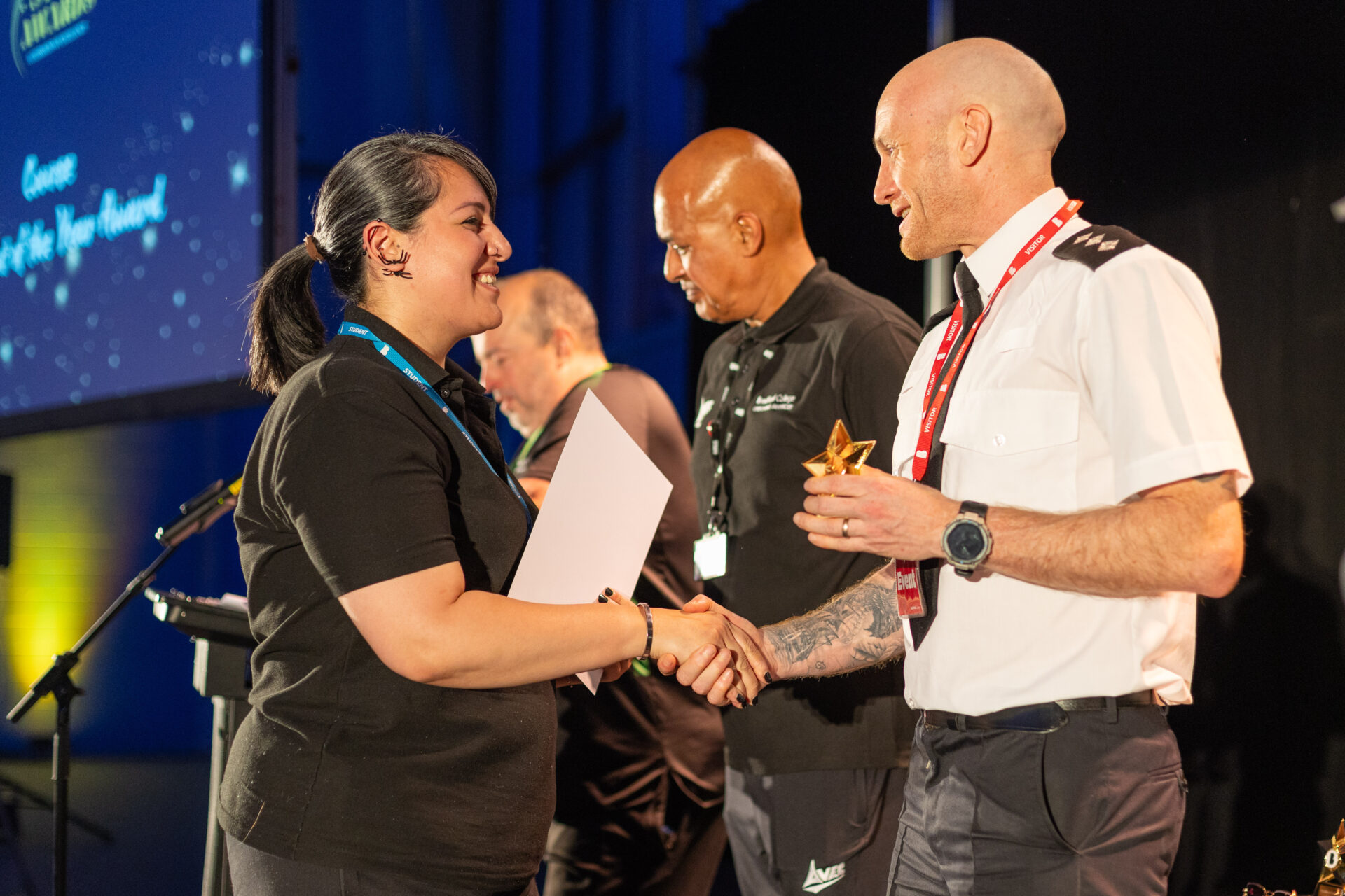 Female student Sahira Jan being presented with an award from the chief inspector