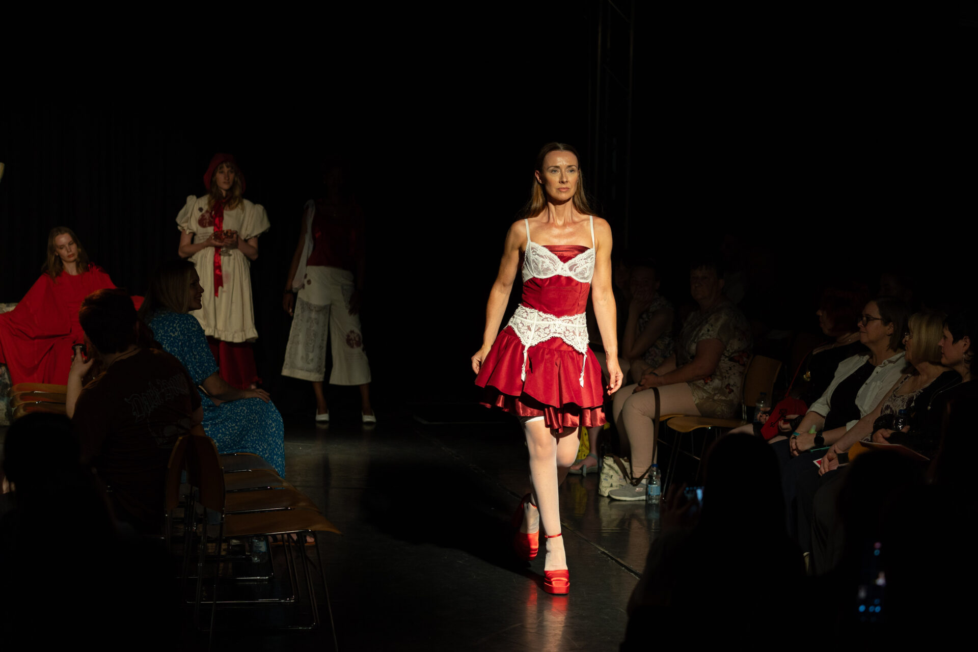 Student walking down the catwalk in the Summer Show 2025