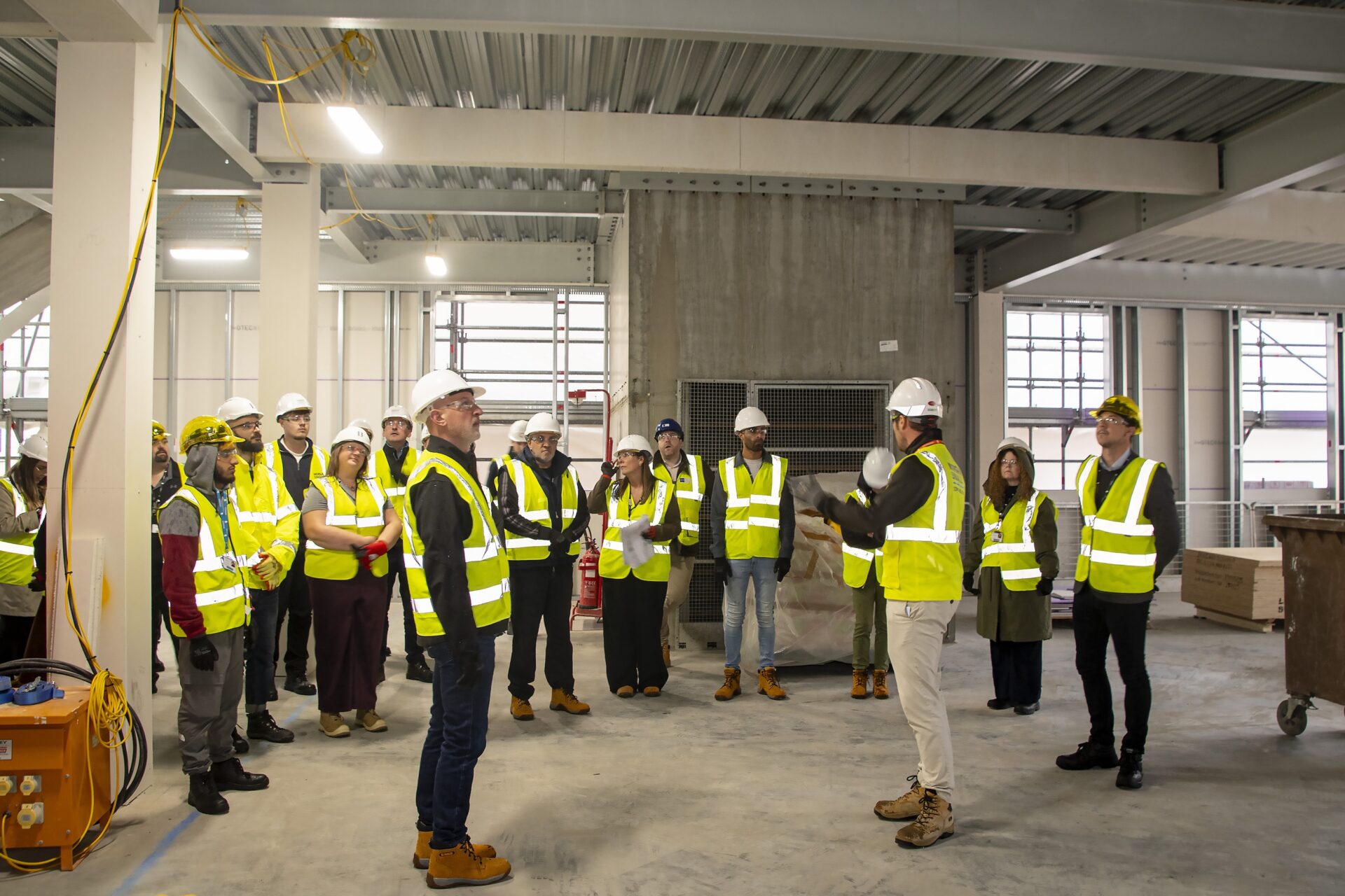 An image of 6. Bradford College Governors and staff with Morgan Sindall Project Manager Dan Marsh (far right) on the top of the new Junction Mills building.