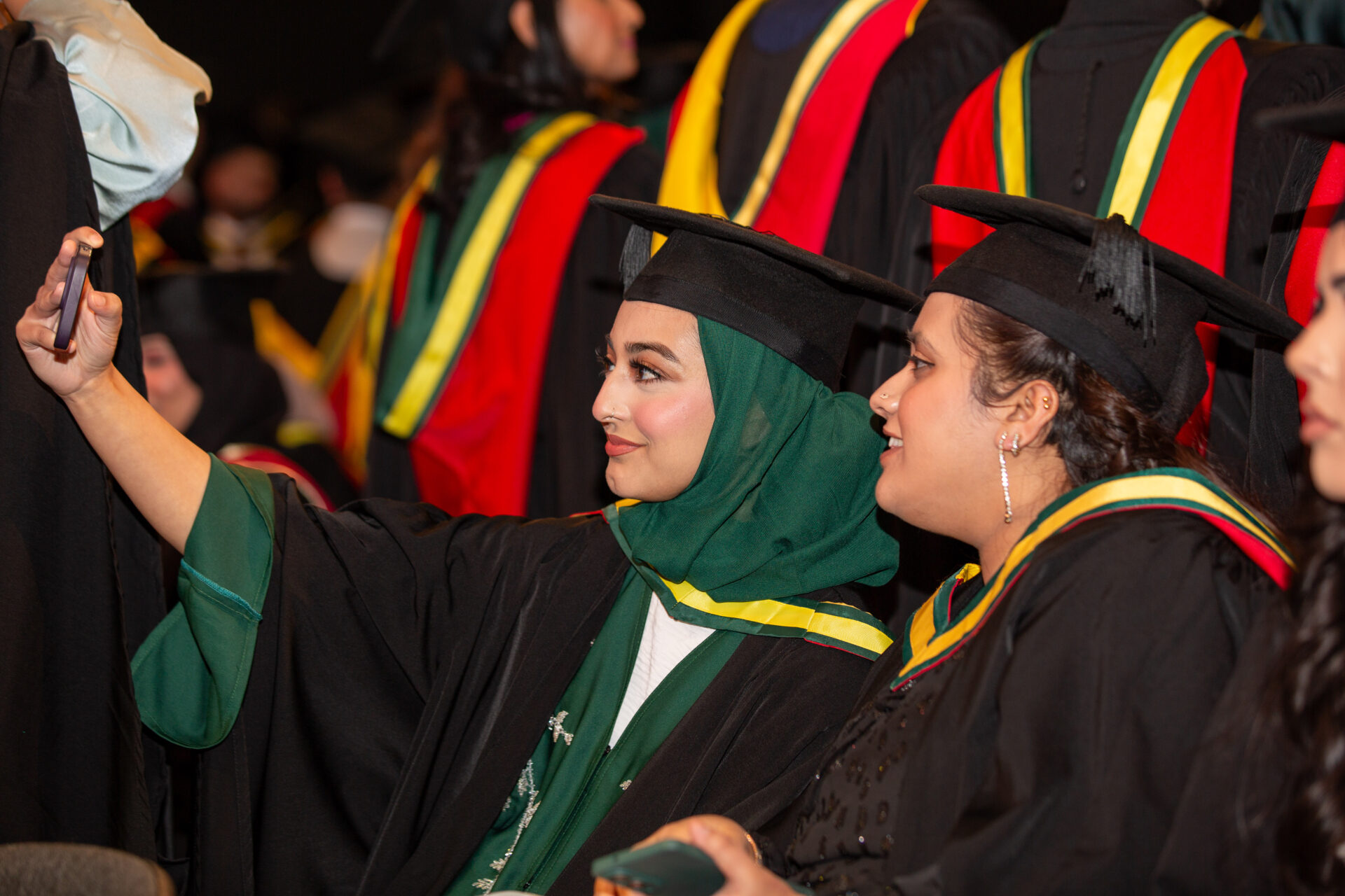 An image of graduates taking a selfie at Graduation
