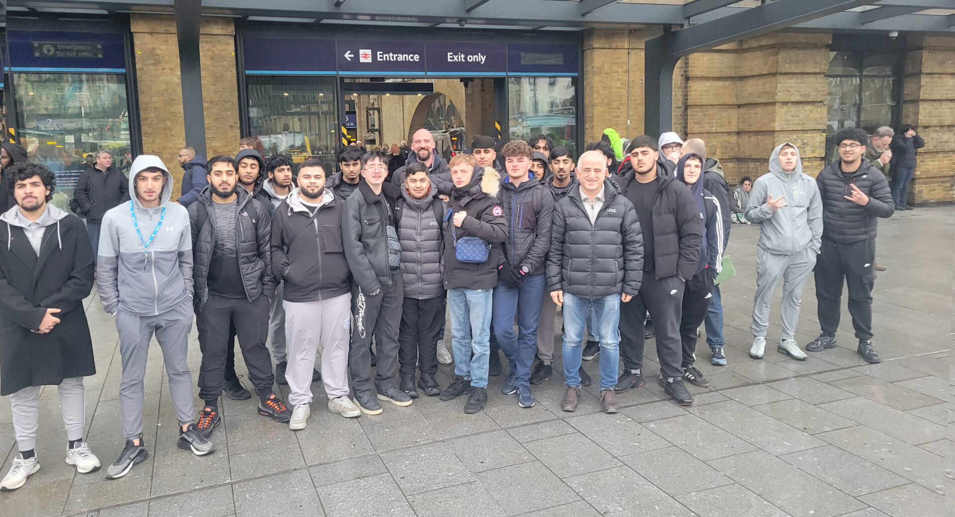 An image of Construction students outside a train station in London