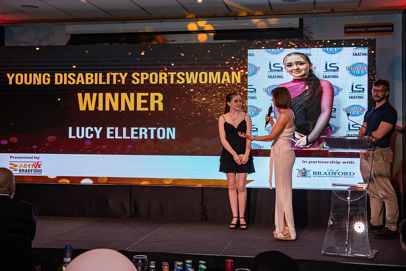 A young female winning an award at the Bradford Sports Awards
