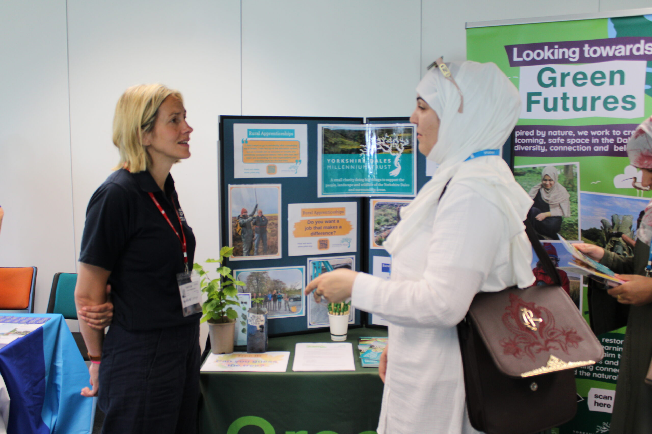An adult learner speaks with a visitor from the Yorkshire Dales Millennium Trust about their volunteering opportunities.