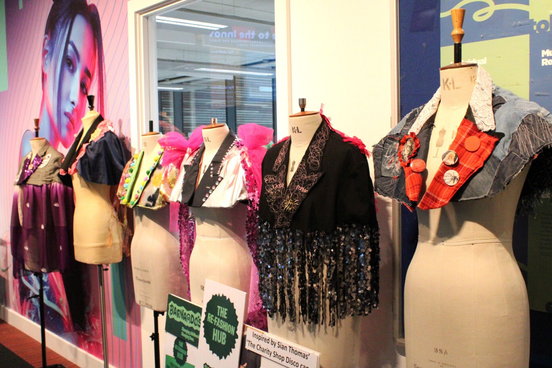 Six mannequin dummies stand in a row wearing colourful sparkly capes made by Bradford College fashion students.