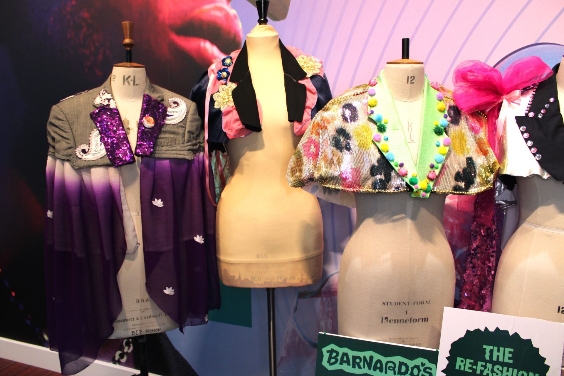 Three mannequin dummies stand in a row wearing colourful sparkly capes made by Bradford College fashion students.